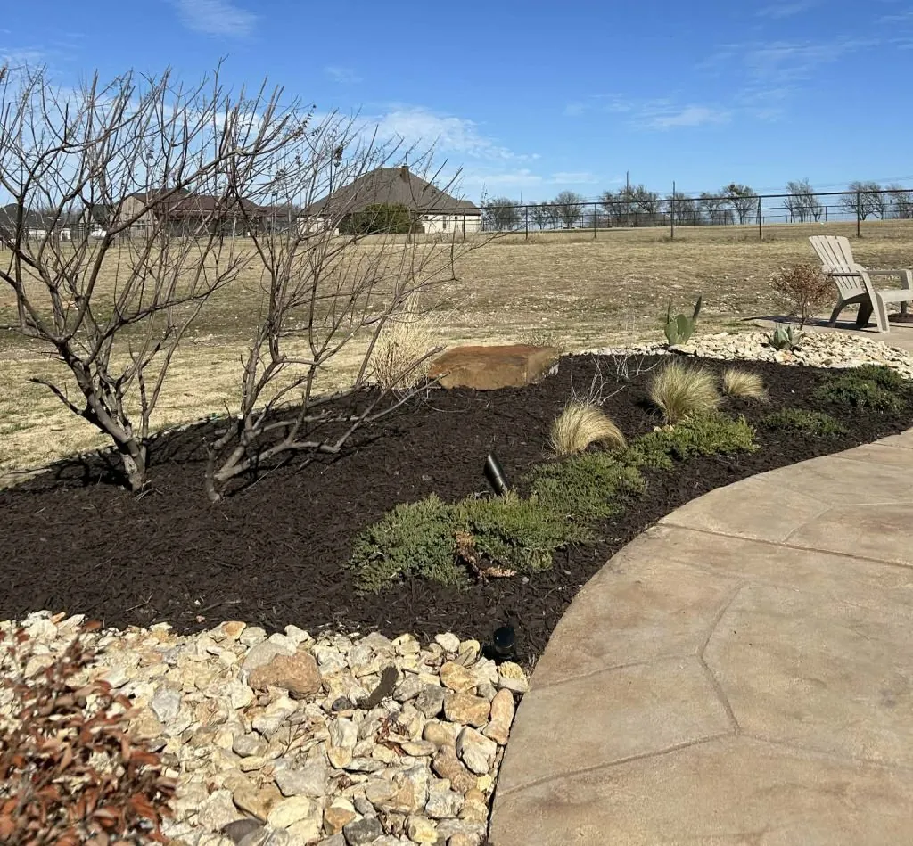 Decorative rock and mulch installation for a finished Burleson, Texas landscape